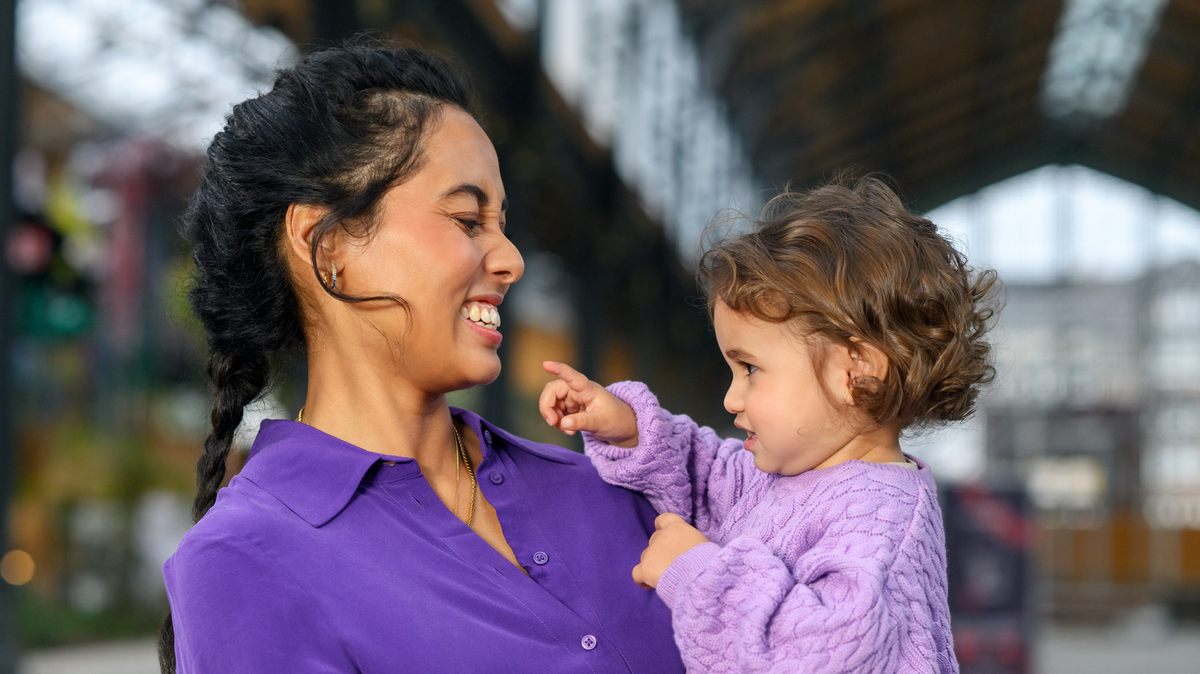 smiling mom holding toddler