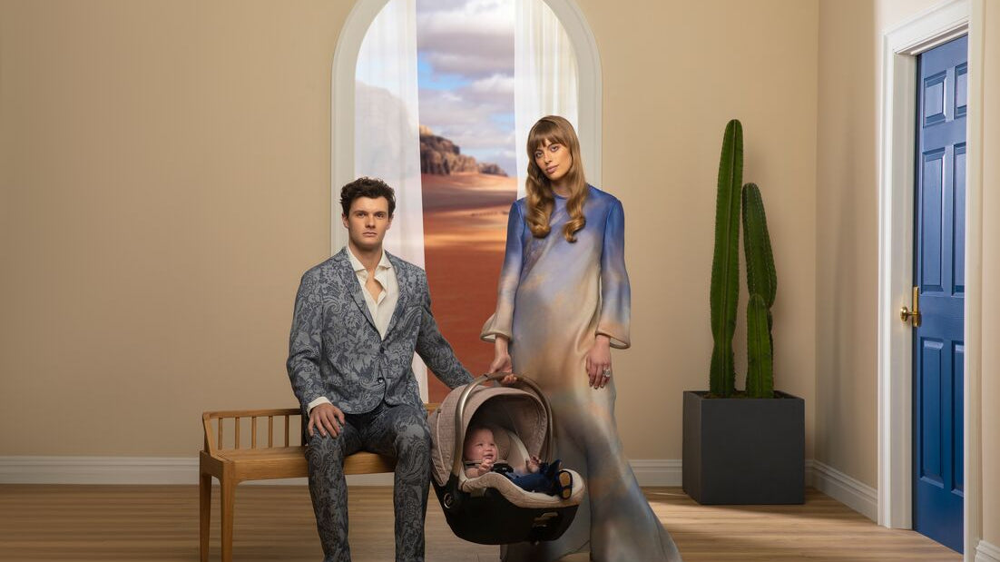 Mother and father holding infant car seat