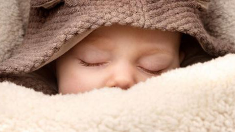 baby bundled up in car seat