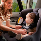 Woman adjusting a baby's car seat in a vehicle