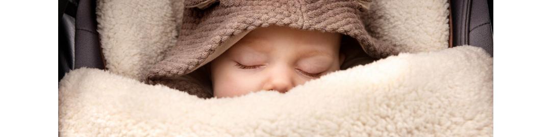 baby bundled up in car seat