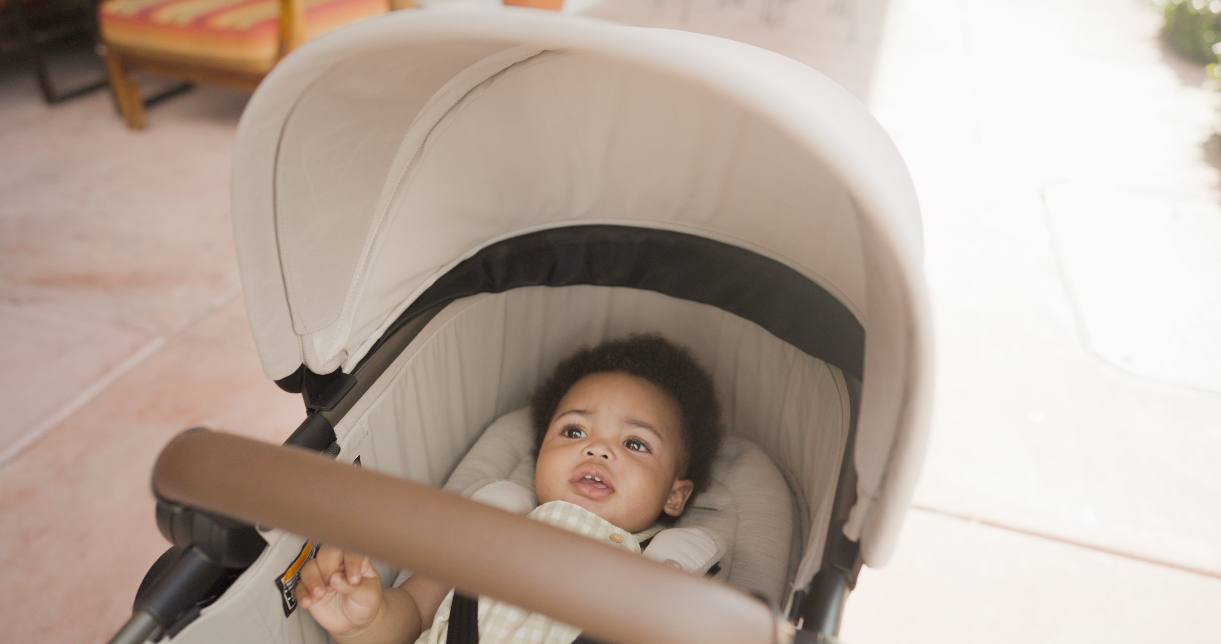 Toddler smiling in stroller