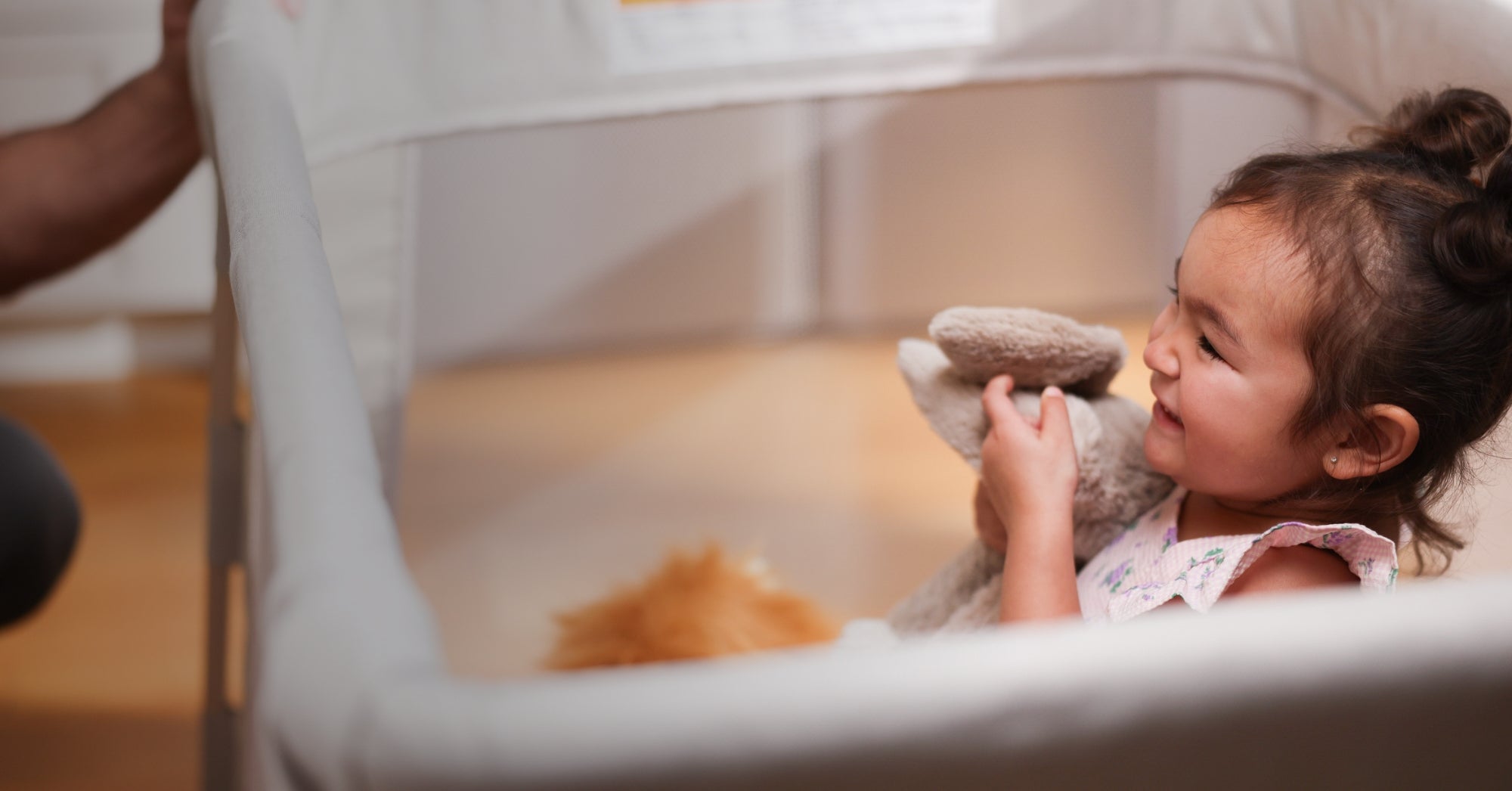 toddler enjoying time in a Maxi-Cosi play yard