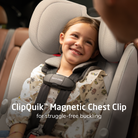 Child in a car seat with a ClipQuik Magnetic Chest Clip, smiling.