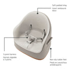 Detailed view of the soft padded seat inlay, the secure adjustable 3-point harness, and the stable non-slip rubber feet.