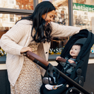 Tayla™ Travel System - mother smiling at son sitting in rear-facing stroller mode