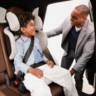 Tanza Belt-Positioning Booster Car Seat - father smiling at son in seat