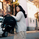 Tayla™ Travel System - woman carrying folded up Tayla