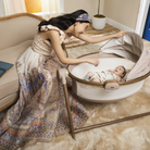 Sibia Bassinet - mother smiling at baby in bassinet