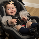 Baby smiling in Peri Infant Car Seat